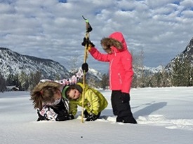 Kids measuring snow